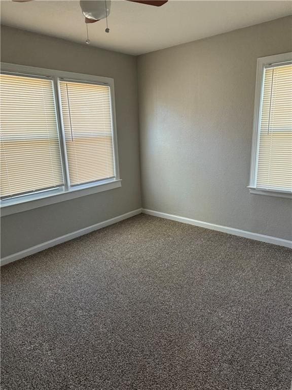 carpeted empty room featuring ceiling fan