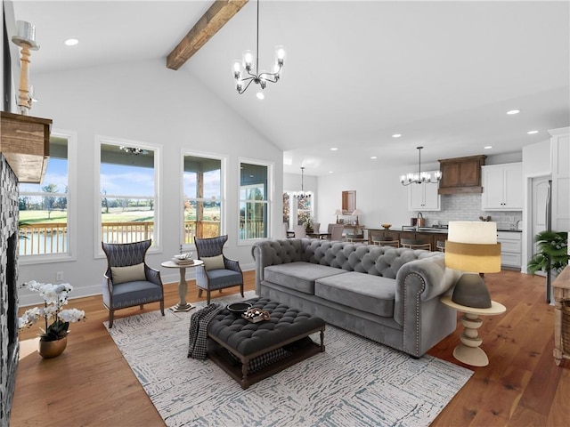 living room featuring beam ceiling, high vaulted ceiling, and light hardwood / wood-style flooring