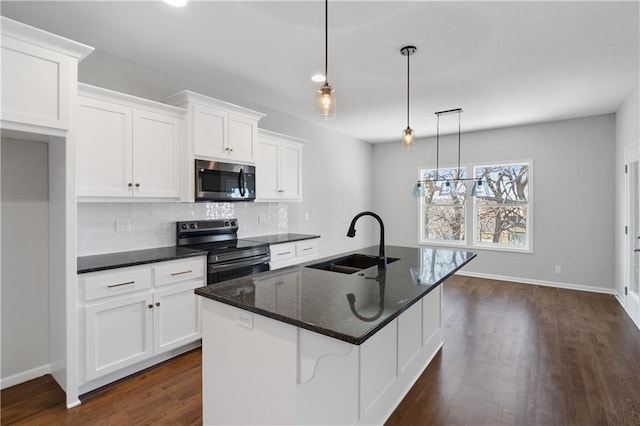 kitchen with sink, pendant lighting, a center island with sink, white cabinets, and black range with electric stovetop