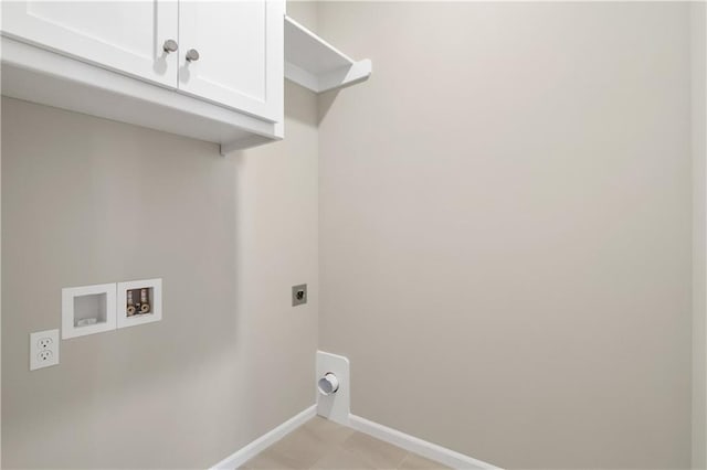 clothes washing area with washer hookup, electric dryer hookup, and cabinets