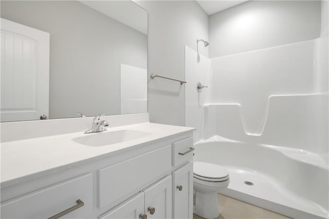bathroom with tile patterned flooring, toilet, vanity, and walk in shower