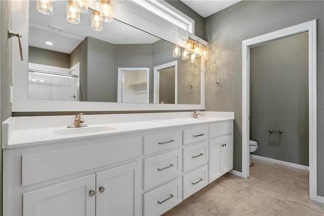 bathroom with vanity, toilet, and walk in shower