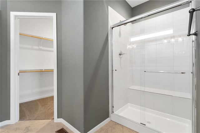 bathroom with tile patterned floors and an enclosed shower
