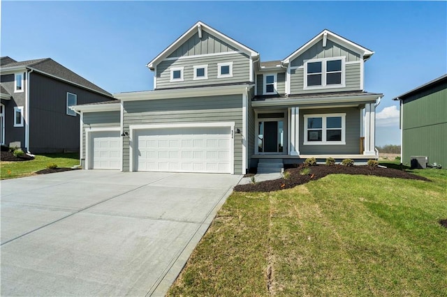 view of front of home with a front lawn and a garage