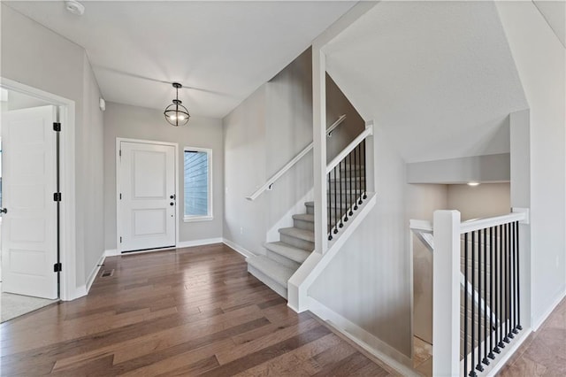 foyer entrance featuring wood finished floors and baseboards