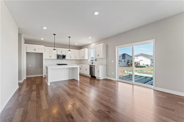 kitchen with white cabinetry, appliances with stainless steel finishes, and baseboards