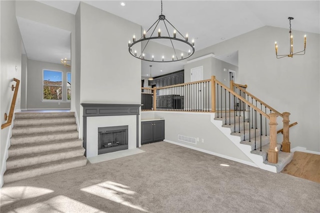 unfurnished living room with carpet floors and vaulted ceiling