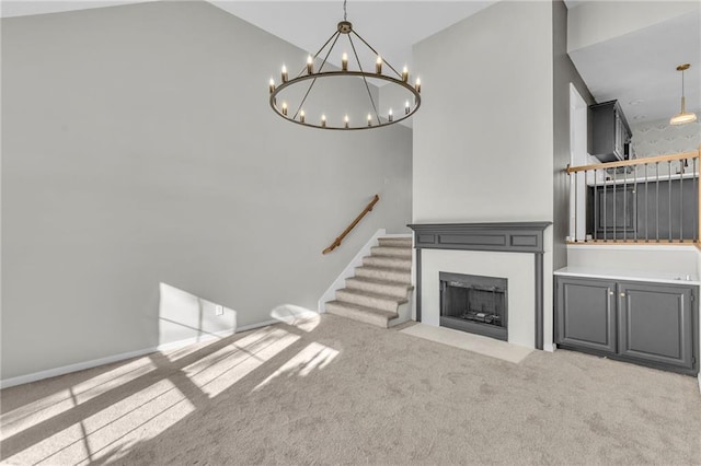 unfurnished living room featuring lofted ceiling and light carpet