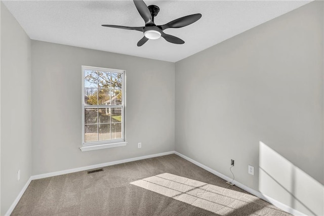 empty room with ceiling fan and light colored carpet