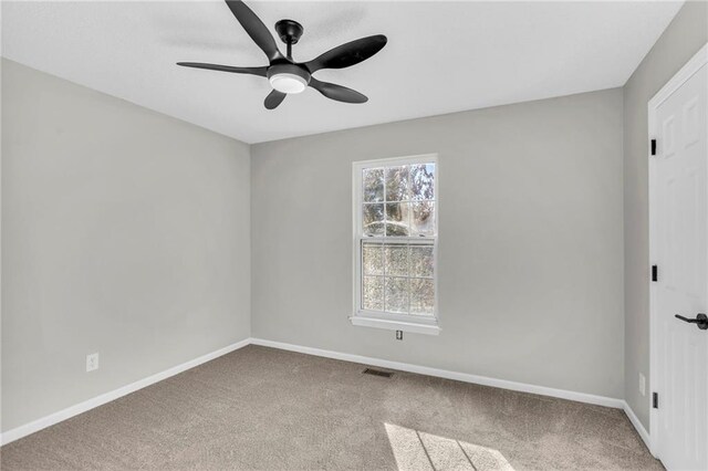 carpeted empty room with ceiling fan