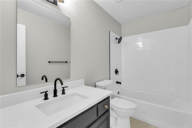 full bathroom with vanity, tiled shower / bath combo, a textured ceiling, and toilet