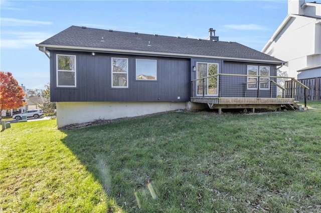 back of property featuring a yard and a deck