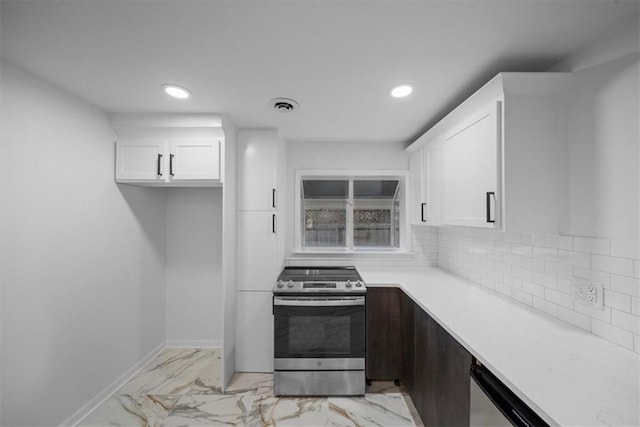 kitchen featuring visible vents, appliances with stainless steel finishes, white cabinets, and decorative backsplash