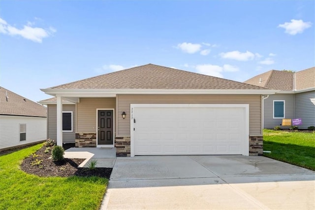 view of front of home with a front yard and a garage