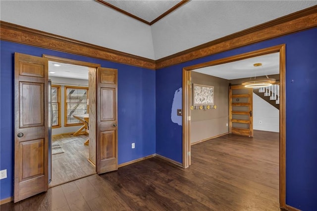 unfurnished room featuring dark wood-style floors, crown molding, and baseboards