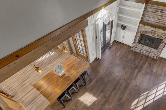 living room with a fireplace and wood finished floors