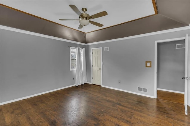 spare room featuring visible vents, a ceiling fan, ornamental molding, wood finished floors, and baseboards