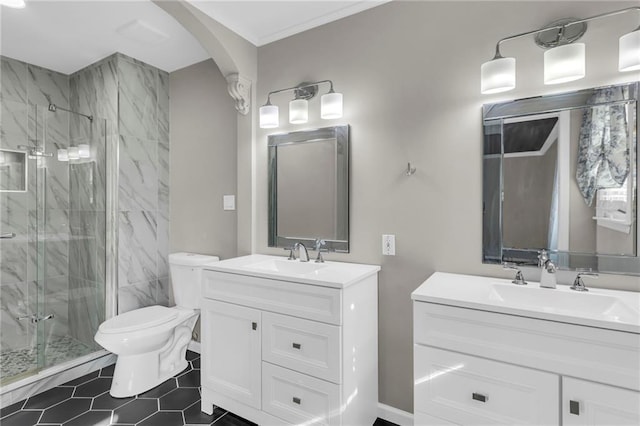 bathroom featuring toilet, two vanities, a sink, and a marble finish shower