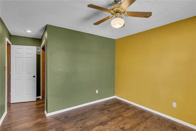 unfurnished room featuring baseboards and wood finished floors