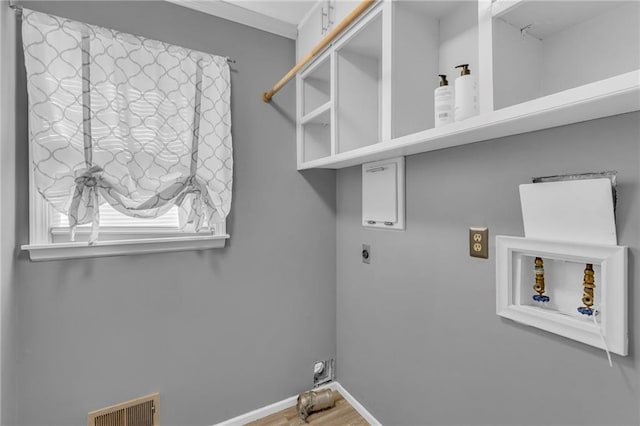 washroom featuring laundry area, washer hookup, visible vents, baseboards, and electric dryer hookup