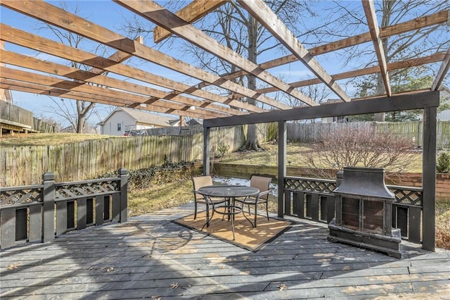 wooden deck with outdoor dining area, a fenced backyard, and a pergola