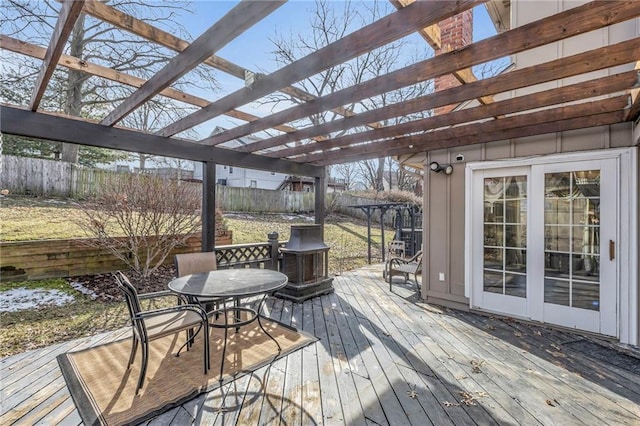 wooden deck with outdoor dining area, a fenced backyard, and a pergola