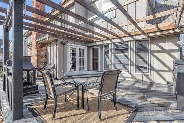 wooden terrace featuring a pergola and outdoor dining space