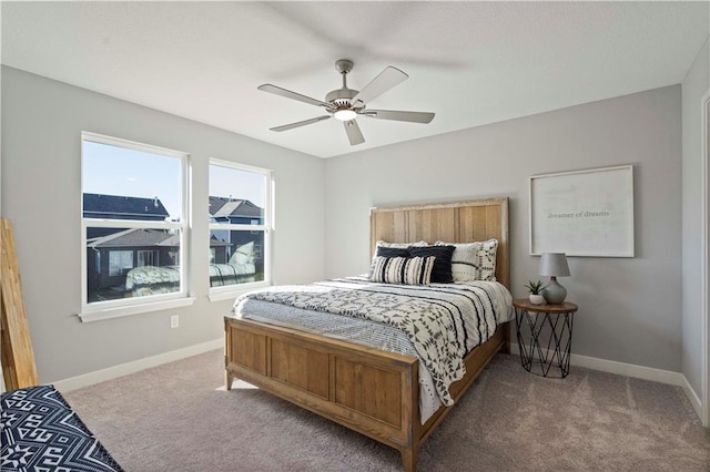 bedroom featuring ceiling fan and carpet