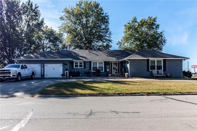 single story home with a front lawn and a garage