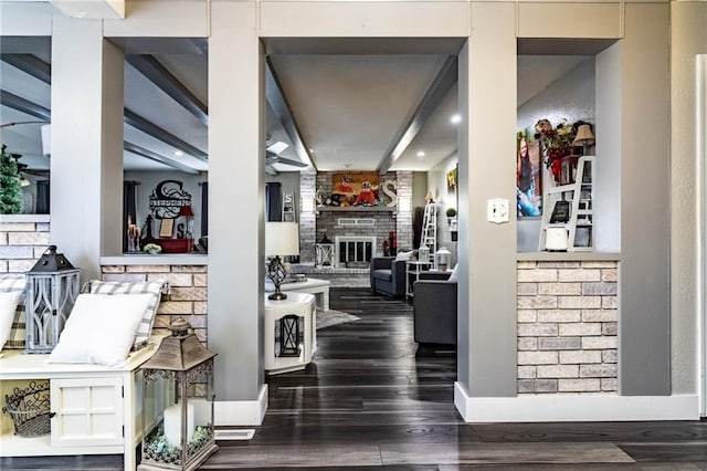 interior space with beam ceiling and dark hardwood / wood-style floors