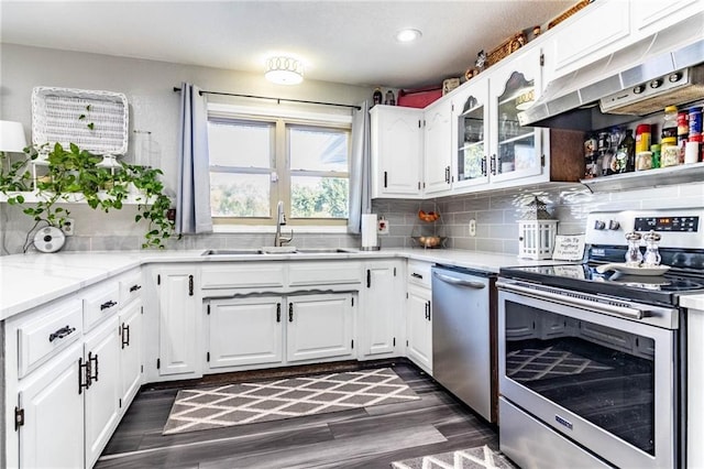 kitchen featuring dark wood-type flooring, sink, white cabinets, and stainless steel appliances