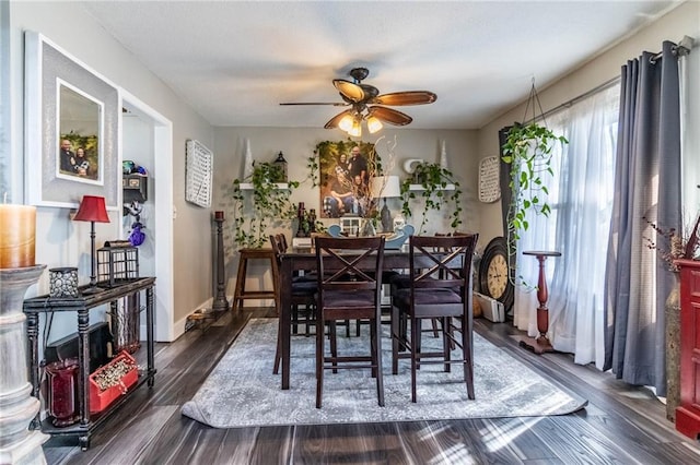 dining space featuring ceiling fan and dark hardwood / wood-style floors