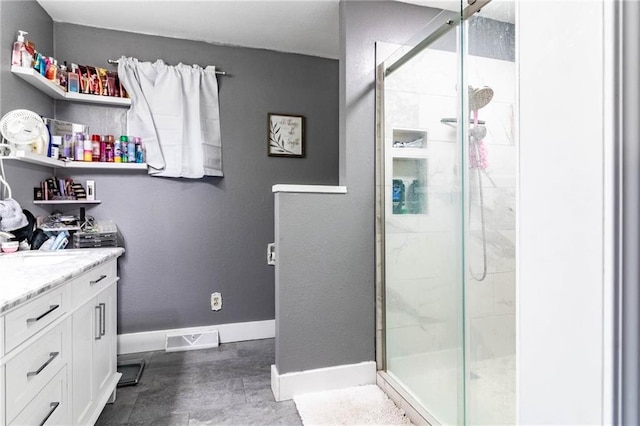 bathroom with vanity and a shower with shower door