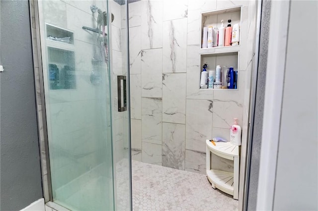 bathroom with a shower with door