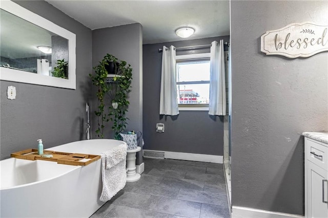 bathroom with vanity and a bathtub