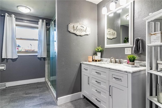 bathroom featuring vanity and an enclosed shower