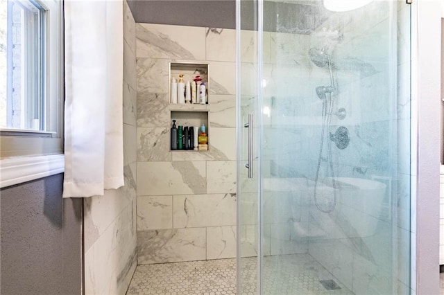 bathroom featuring a shower with shower door