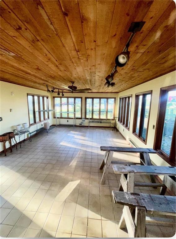 unfurnished sunroom with vaulted ceiling, wood ceiling, and track lighting