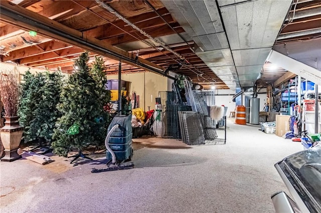 basement featuring carpet floors and water heater