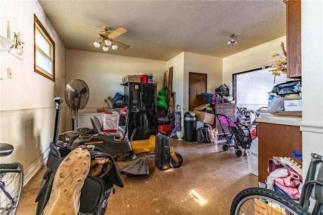 interior space featuring ceiling fan and a textured ceiling