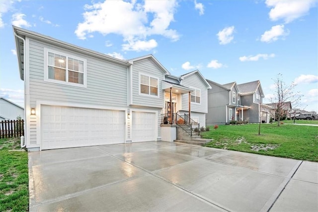 split foyer home featuring a garage and a front lawn