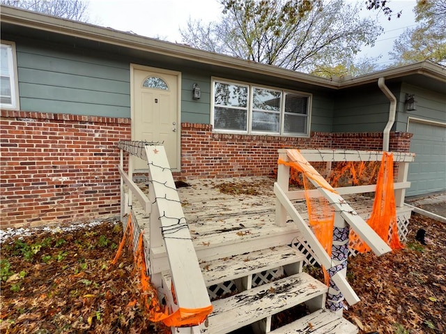 doorway to property with a garage