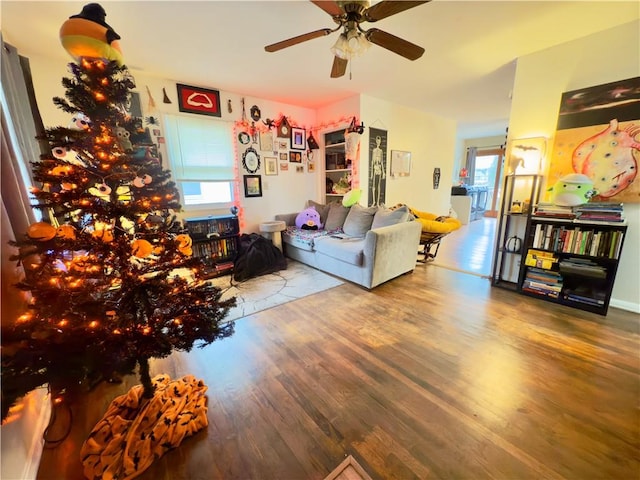 living room featuring hardwood / wood-style flooring and ceiling fan