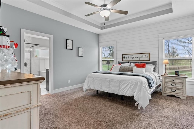 carpeted bedroom featuring a tray ceiling, multiple windows, crown molding, and ceiling fan