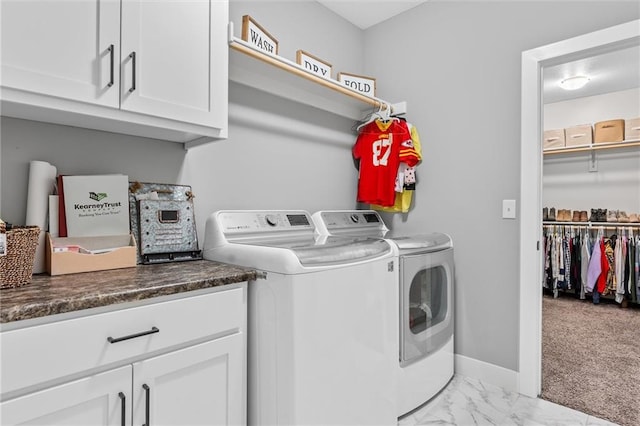 laundry room with washer and dryer, light carpet, and cabinets