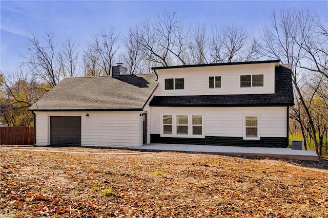 view of front of property with central AC and a garage