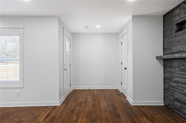 hallway featuring a healthy amount of sunlight and dark hardwood / wood-style floors