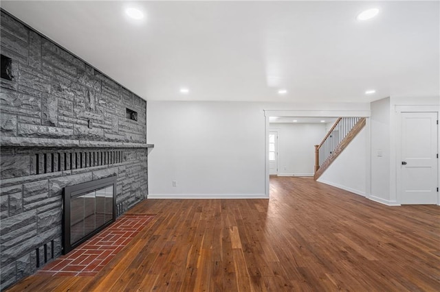 unfurnished living room featuring dark hardwood / wood-style flooring and a fireplace