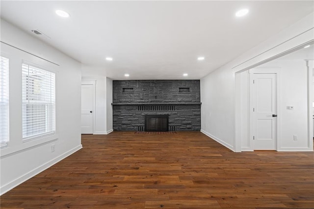 unfurnished living room with a fireplace and dark hardwood / wood-style flooring