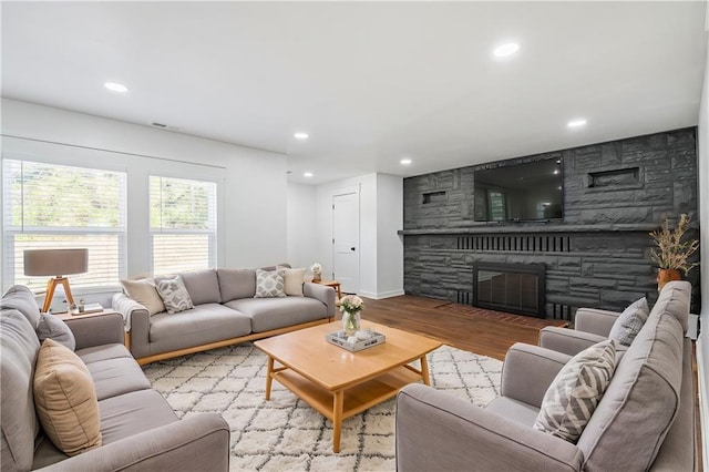 living room with light wood-type flooring and a fireplace